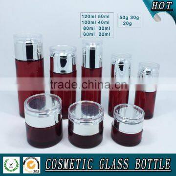 Red coloured cosmetic glass pump bottles and glass cream jars