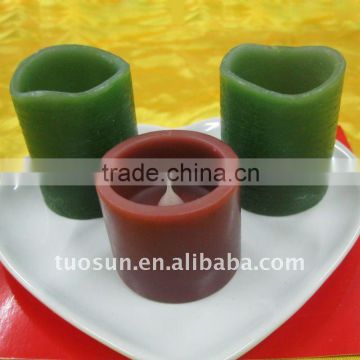 small colorful wax led votive candle with crater