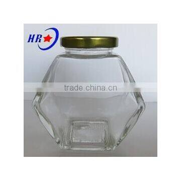 holding 250g Honey glass jar with golden lid