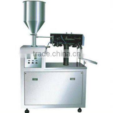 Metalic tube filling and sealing machine