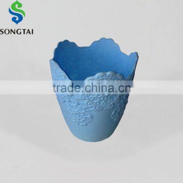 small round flower pot with embossed flowe design