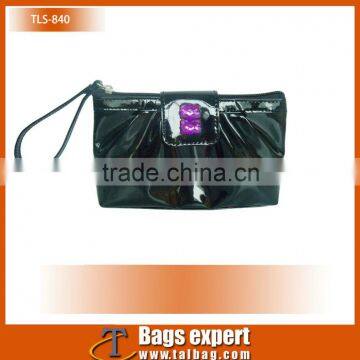 Black shiny pu cosmetic bag for lady with clear diamond as decoration with wrist strap.