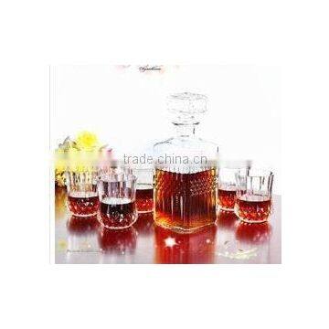 clear glass wine bottle with glass cups