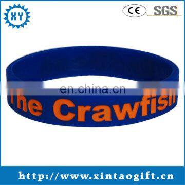 Personalized blue rubber bracelets with orange filled