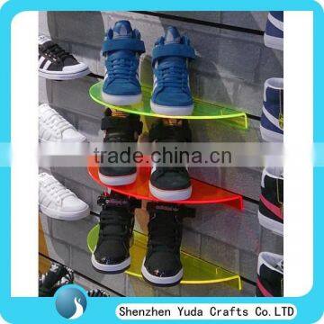 Many fluorescent colored semicircular plexiglass slatwall display rack