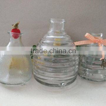 Hanging glass bee catcher with metal handle and wood cork stopper for home and garden use