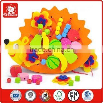 a string of beads put into a wood hedgehog shape beauty small furit styles of the perler beads making wood toys kids wooden toys