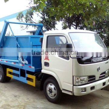 Swing arm garbage truck