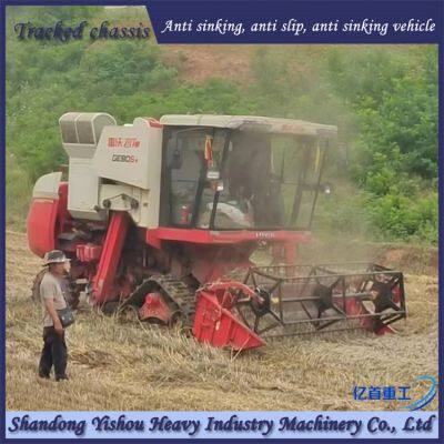 Modification of wheat harvester with triangular track wheels to prevent slipping on muddy ground