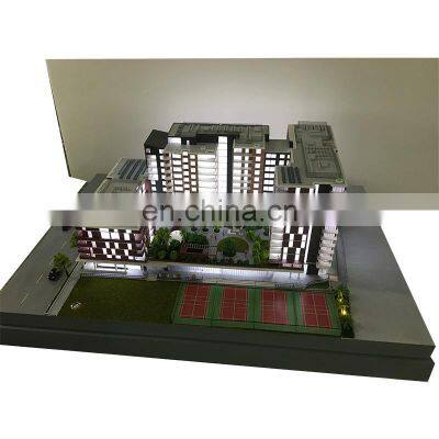 Ho scale building maquette with static grass figures, diorama architectural model