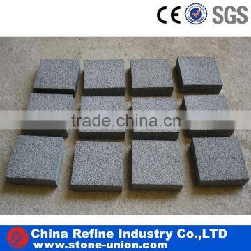 Bush-hammered finished grey basalt cube