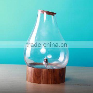 Glass drink dispenser with tap and wooden cover and base
