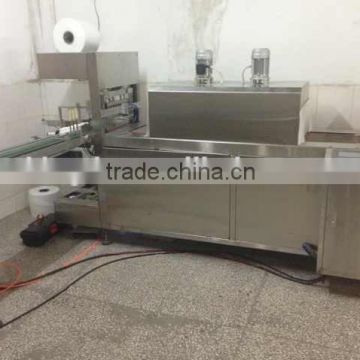 Fully automatic shrink wrapping machine