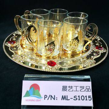 Glass cup with gold tray