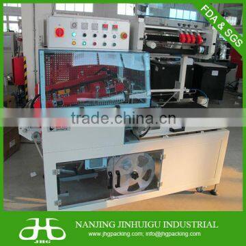 Vertical L type shrink wrapping machine