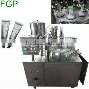 Cosmetic tube filling and sealing machine