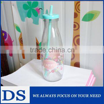 Clear glass milk/juice bottle with decal and plastic lid