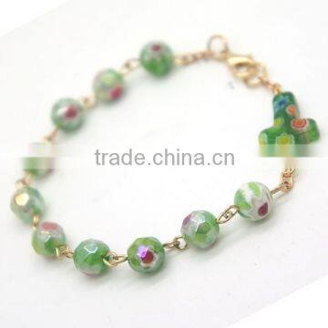 Colorful faceted beads and cross connected by lobster clasp