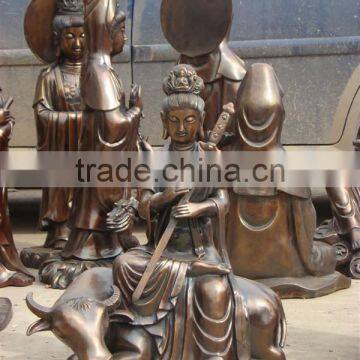bronze kyan yin statue with sword sitting on cow sculpture