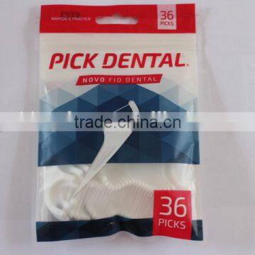 White dental floss pick in bag