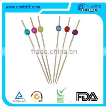 Disposable fruit skewers with colorful plastic decorate