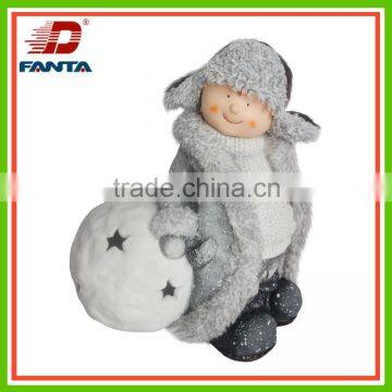 Standing magnesium winter child with felt hat with candle holder