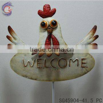 welcome sign stick decoration in yard with chicken head