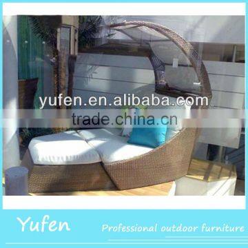 Outdoor rattan sun lounger with shade