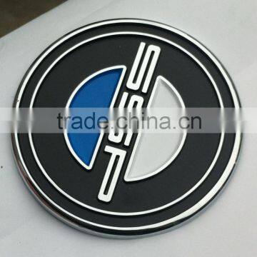 Chrome badge with soft enamel.