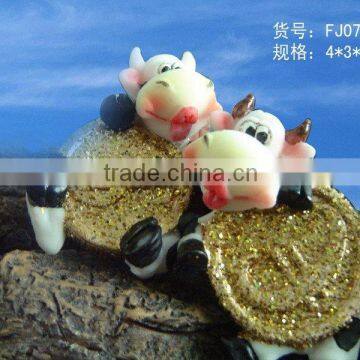 Polyresin cow with coin