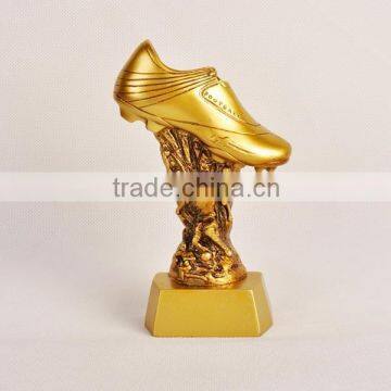 Gold football shoe with figure trophy