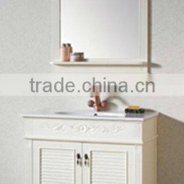 White wooden bathroom vanity with attached mirror.