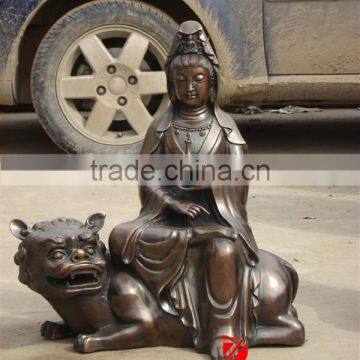 metal buddha statue sitting on tiger sculpture