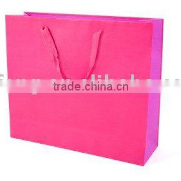 paper bag with red ribbon