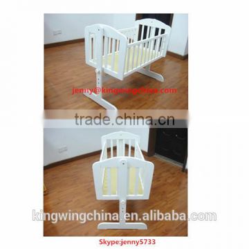 white wooden baby cradle bed