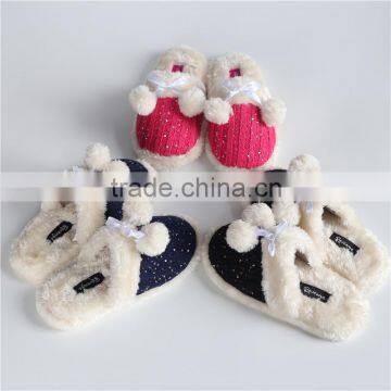 Woman knitted indoor slipper with pom pom