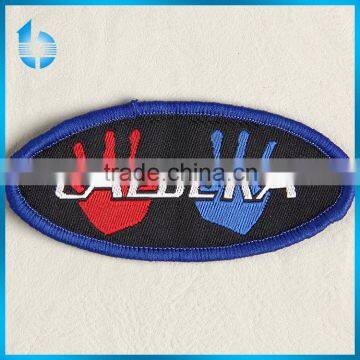Customize elliptical shaped woven tag with binding for boy's brocade sweater