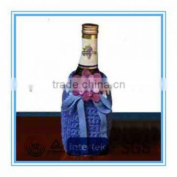 Purple knitted wine bottle cover with flower