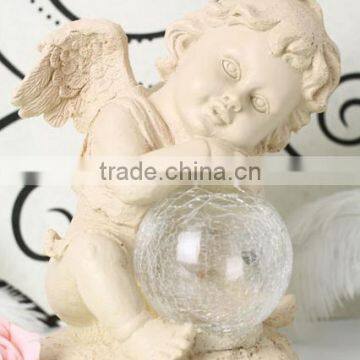 Resin solar lighting angle figurine holding a luminur glass globe garden ornamenet