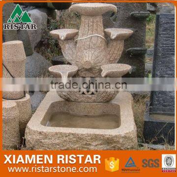 Outdoor stone fountain garden water feature in yellow granite