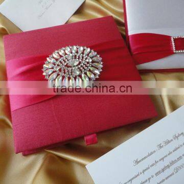 Pink Faux silk wedding invitation box with a large brooch.