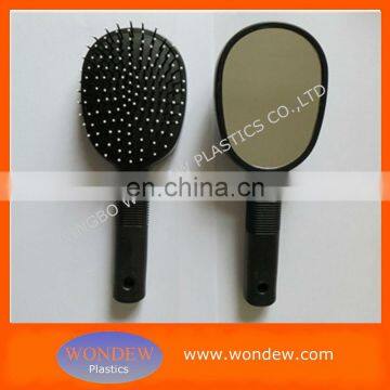 Double sided hairbrush with mirror on back