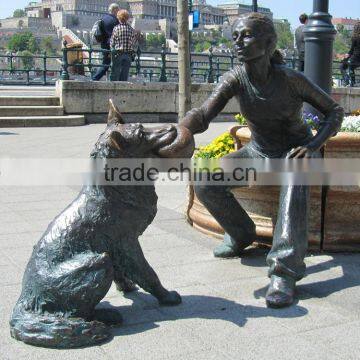 bronze girl with dog playing sculpture