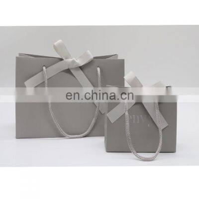 Boutique shop grey paper shoping gift bag with your own embossed silver logo