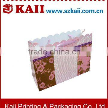 pretty paper shopping bag with ribbon or cord handle