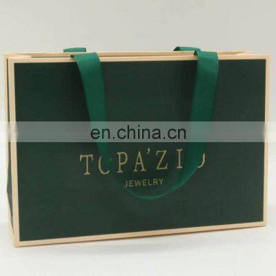 Dark green papre gift bag with ribbon handle