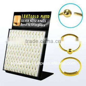 Display board with 96 pcs. of real gold 18k plated sterling silver nose hoops with and without ball