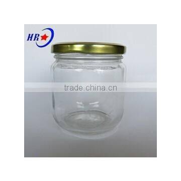 round honey glass jar with golden lid