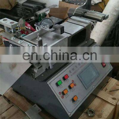 UGS2050 Hot Cold Mini Table Top Automatic Fabric Woven Label Cutting Machine, Small Garment Wash Care Ribbon Cutter photo-2