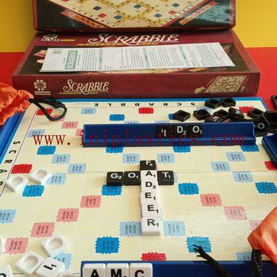 Item:scrabbles Components: 1x4c Printed Box, 1 Manual, 100 Black Tiles, 100 White Tiles, 4 Racks, 1 2 Folded Board, 2 String Bags
